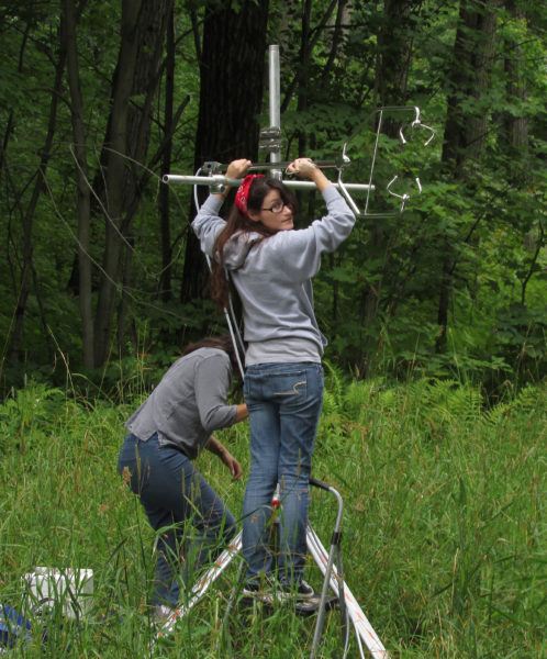 woman sets up an antenna-like sensor