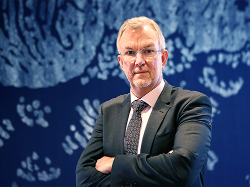 Portrait of Chris Greig against Andlinger Center backdrop