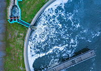 aerial of a large water facility tank full of blue water