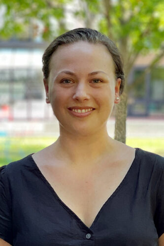 Portrait headshot of a woman with a navy blouse, one of our newest distinguished postdoctoral fellows.