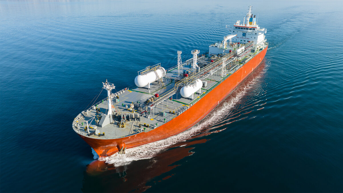 A large orange liquid fuel tanker at sea