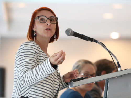 A woman speaks at a podium