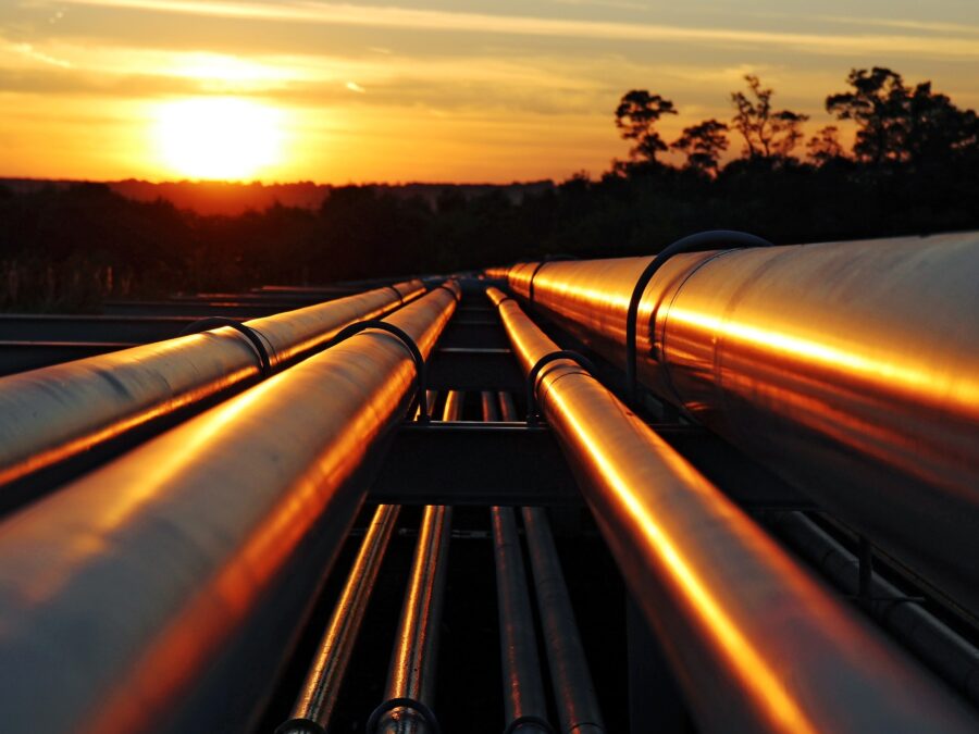 Pipelines with a sunset in the background.