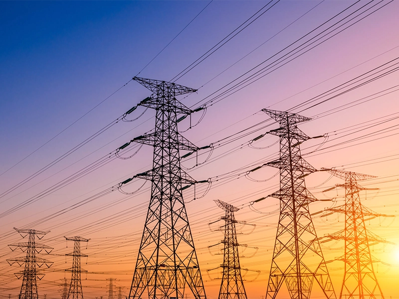 Power lines against a sunset sky