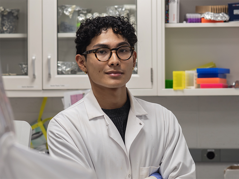 Man wearing a lab coat in a biology lab