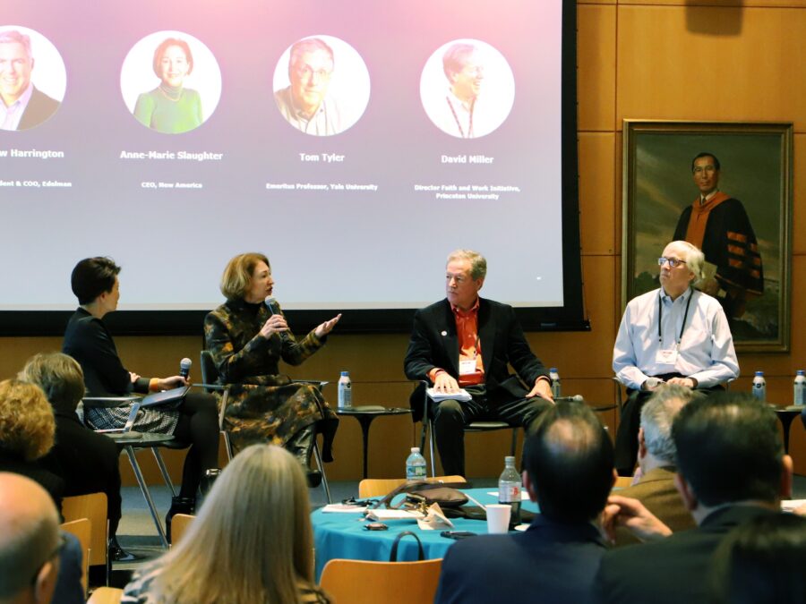 Panelists speak before an audience.