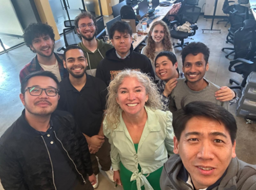 A team of engineers poses for a selfie.
