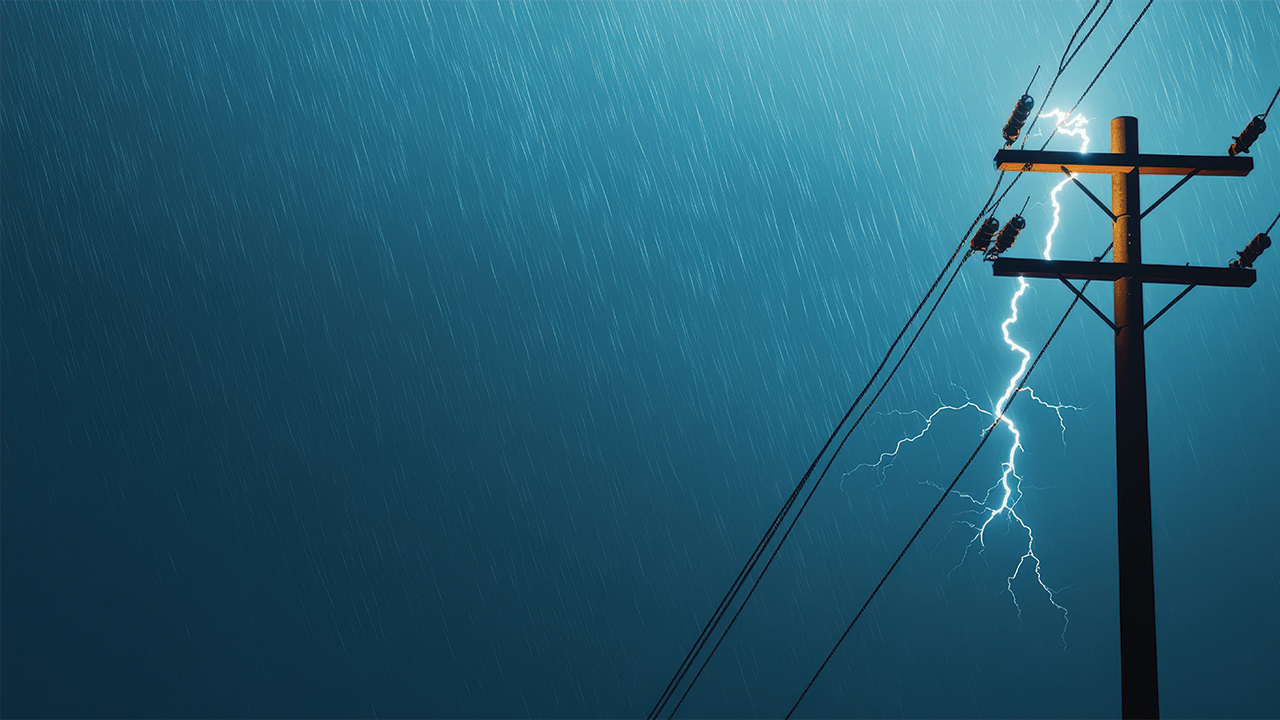 Lightning and rain against a power line pole