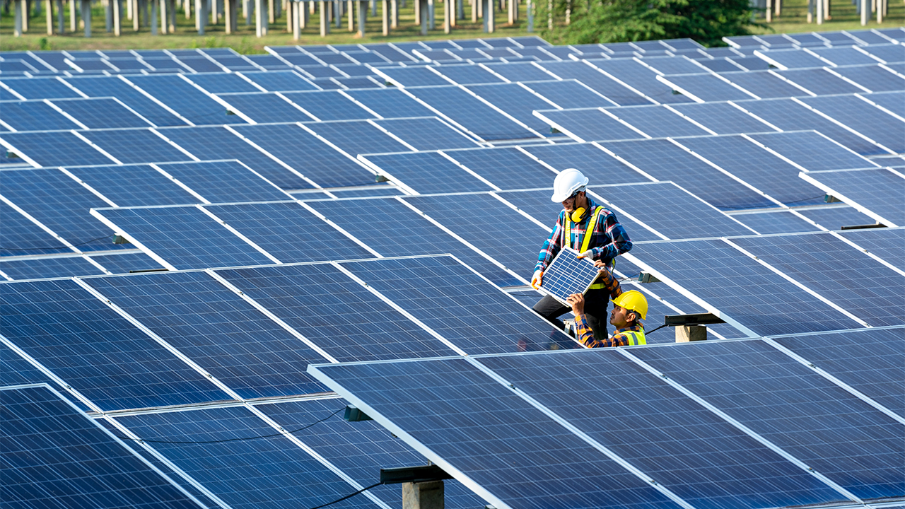 Two engineers work on a solar panel