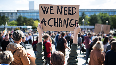 Rear view of people with placards and posters on global strike for climate change.