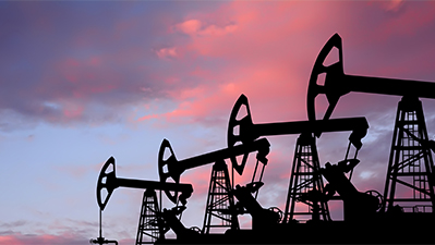 Pump-jacks on sunset background.