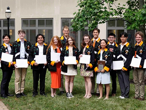 A group of graduating students holding certificates.