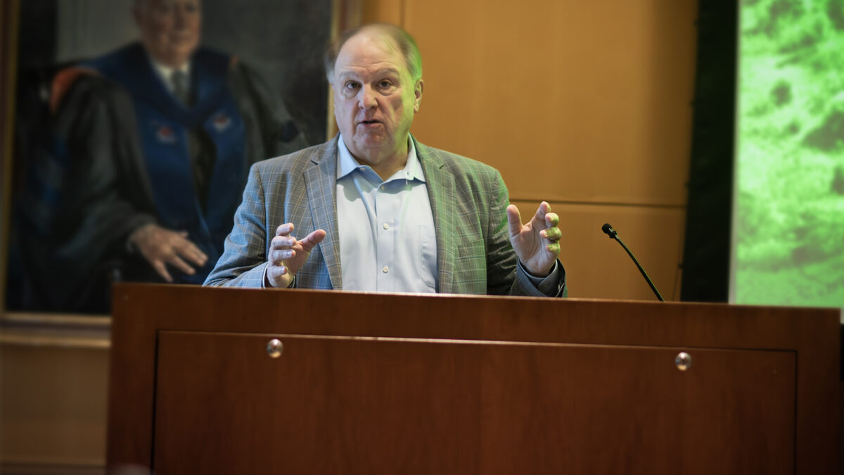 A man speaks at a podium