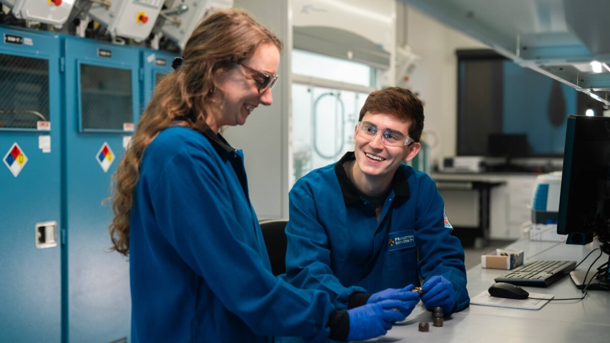 Two researchers in blue lab coats