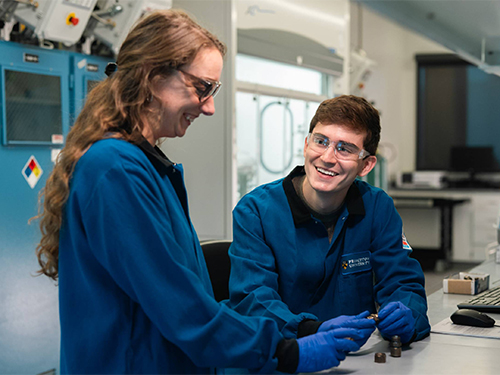Two researchers in blue lab coats