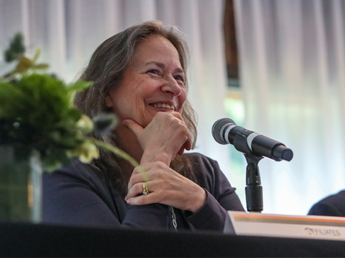Woman speaker smiling.