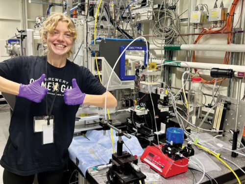Young woman gives a thumbs up and alb setting.